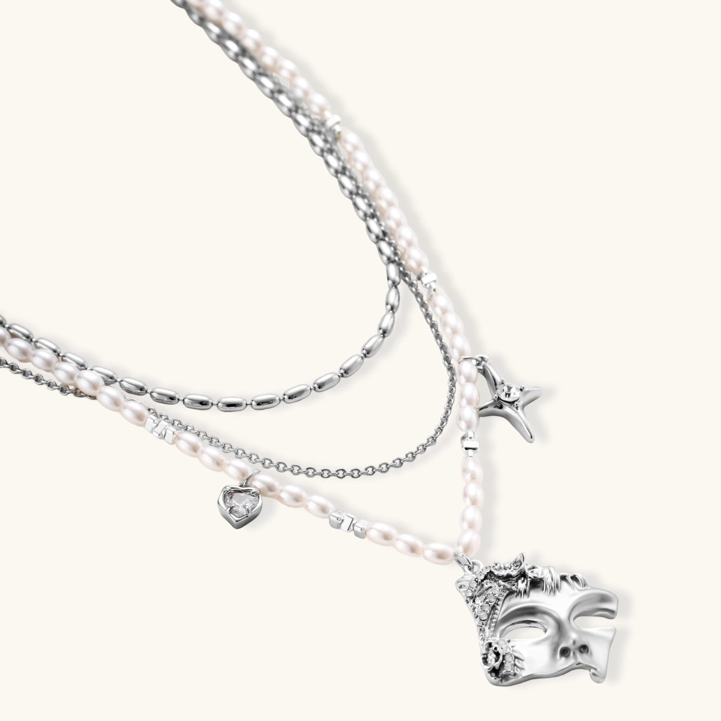 Multi-strand layered necklace set with silver chains, white pearls, star charm, heart pendant, and ornate decorative piece