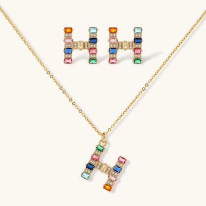 Gold-plated letter H jewelry set with multicolor zirconia stones in emerald cuts, showing necklace pendant and matching earrings