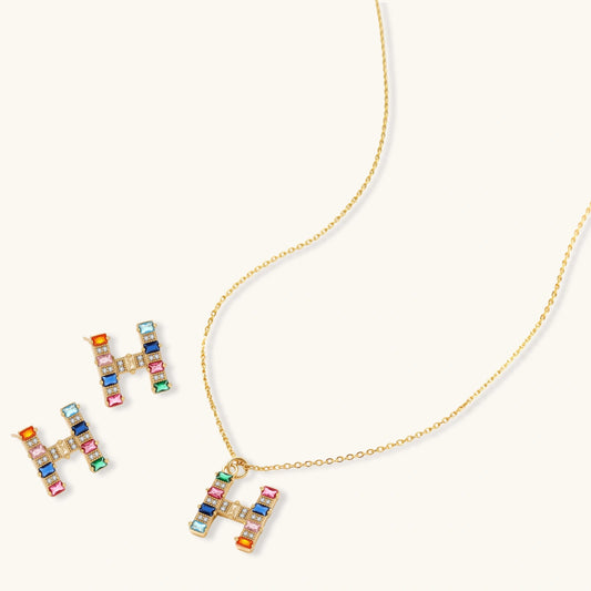 Gold-plated letter H jewelry set with multicolor zirconia stones in emerald cuts, showing necklace pendant and matching earrings