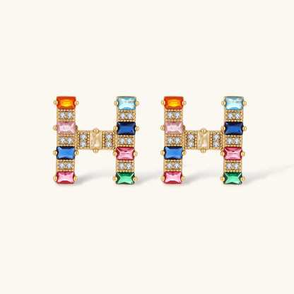 Gold-plated letter H jewelry set with multicolor zirconia stones in emerald cuts, showing necklace pendant and matching earrings
