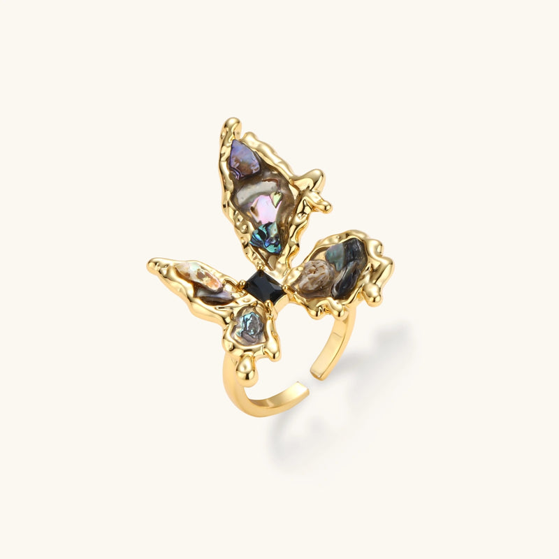 Gold-plated adjustable ring featuring iridescent shell pieces in purple, blue and green tones arranged in butterfly formation