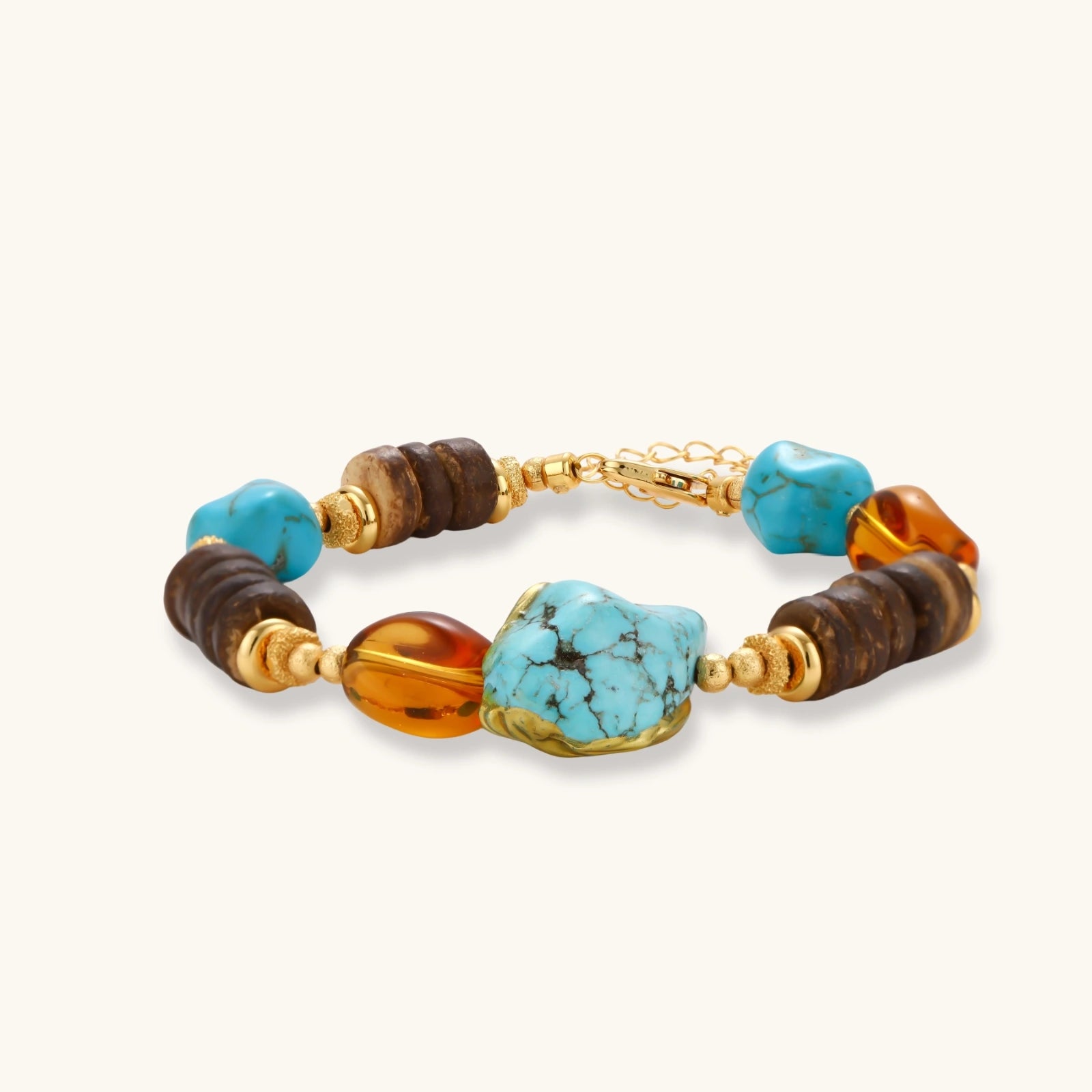 Mixed-material bracelet with turquoise stones, wooden beads, and 18k gold-plated copper elements on white background.